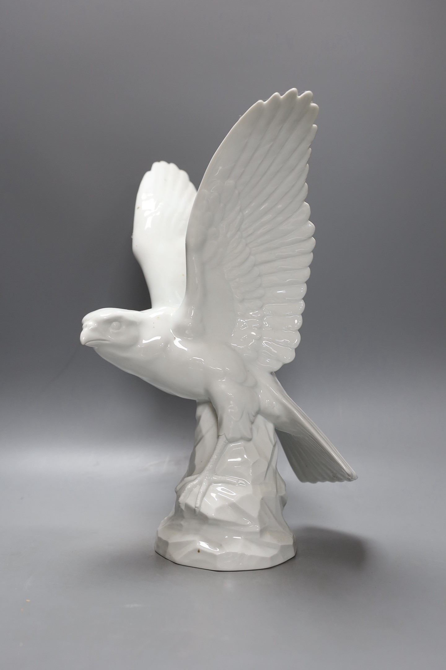 A modern Dresden porcelain model of a perching falcon, 37cms high.